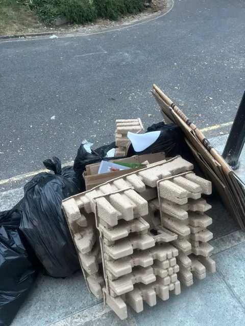 Cardboard and moulded pulp packaging waste at the kerbside in Harlesden NW10