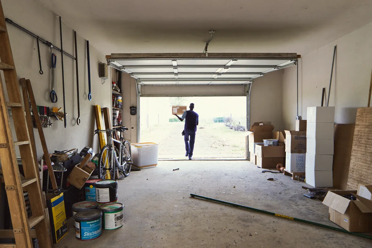 Garage clearance in London — crew clearing tools, boxes and clutter from a garage